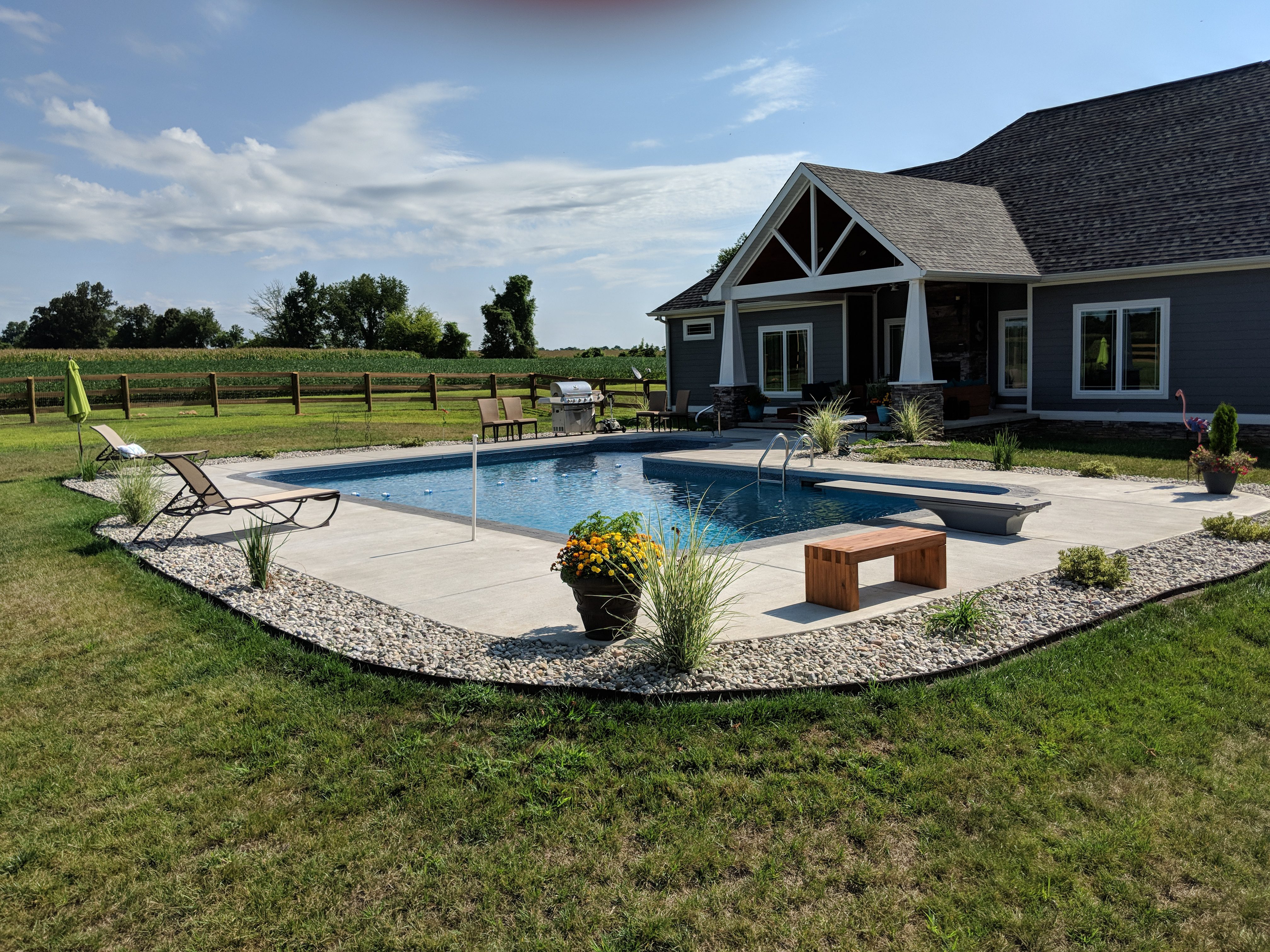 L-shaped pool in a backyard.